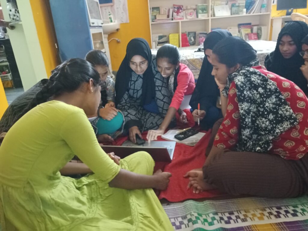 Students in a group designing on Canva together