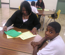 Volunteer helps student with academic scorecard