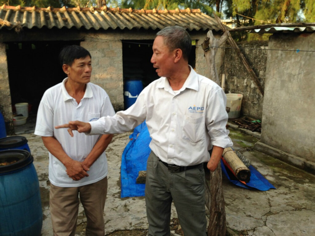 Thuan the AEPD outreach worker advises Mr Duc