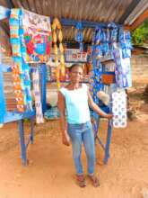 Olivia standing by her table kiosk