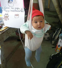 Baby being weighed in Chuicavioc, Guatemala