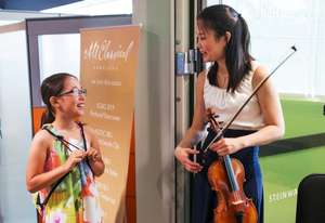 Violinist Katie Hyun speaks with a PYP student