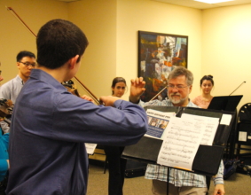 Daniel Phillips coaches PYP musician on technique.