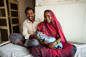 Mother and father with infant