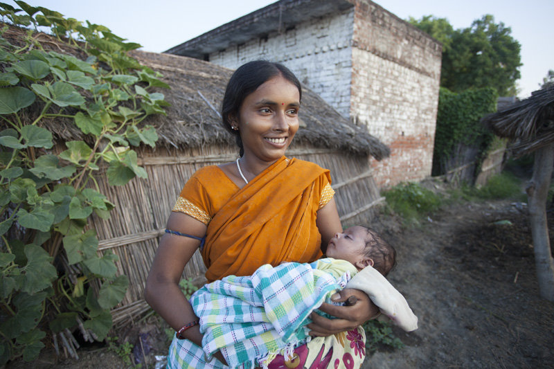 Kiran holding her son in their Raebareli village
