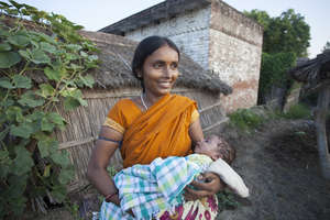 Kiran holding her son in their Raebareli village