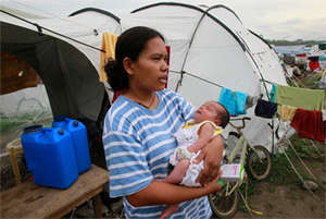 Miraflor Cainoy holding her baby.