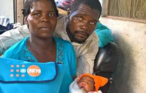 Tina and her family with a UNFPA dignity kit