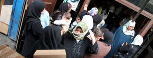 Syrian refugees receiving supplies in Lebanon