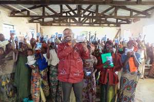 Traditional birth attendants holding up kits