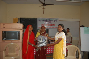 A midwife receiving birthing kits after training