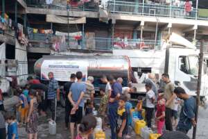 Water distribution at evacuation center in Gaza