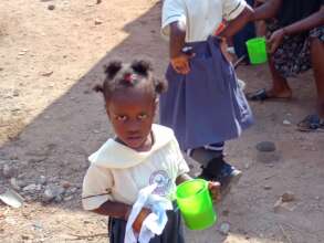 her holding cup of porridge