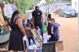 HwwB staff donating clothes to a household in need