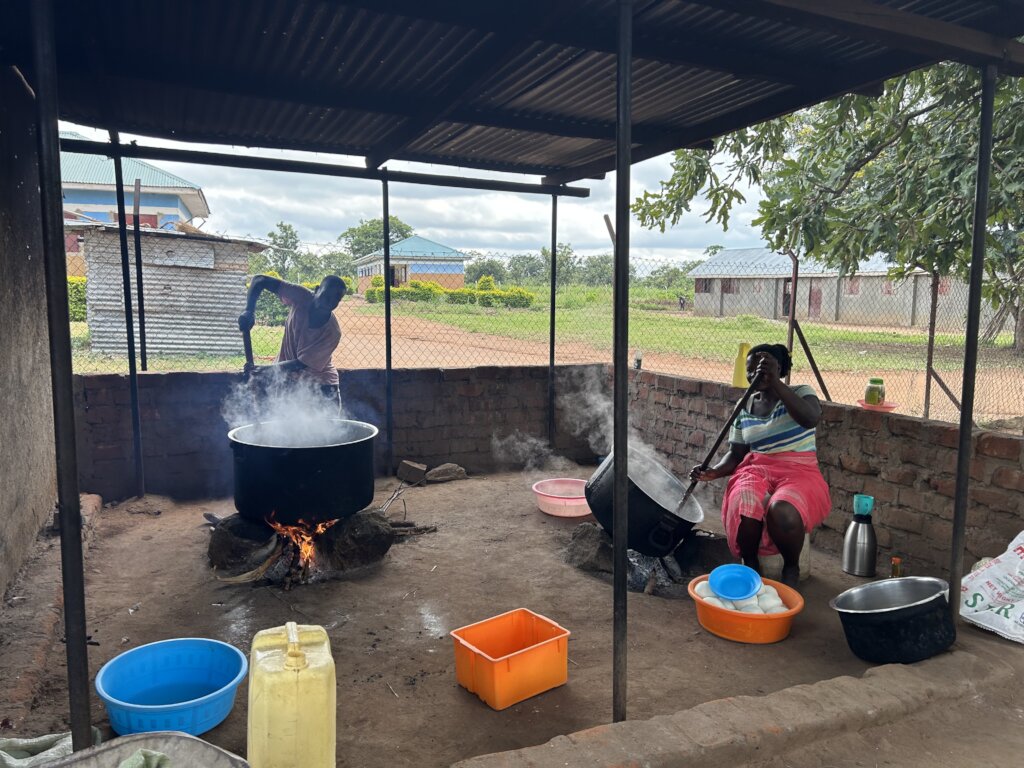 School Cooks Preparing Lunch over Open Fire