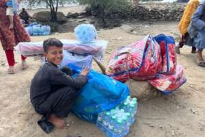A boy receiving relief supplies