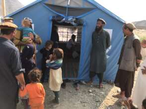 Patients waiting by the tent to see the doctor