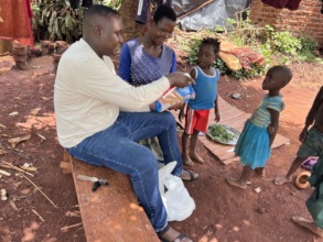 A widow in Kyabirwa Village receiving xmas
