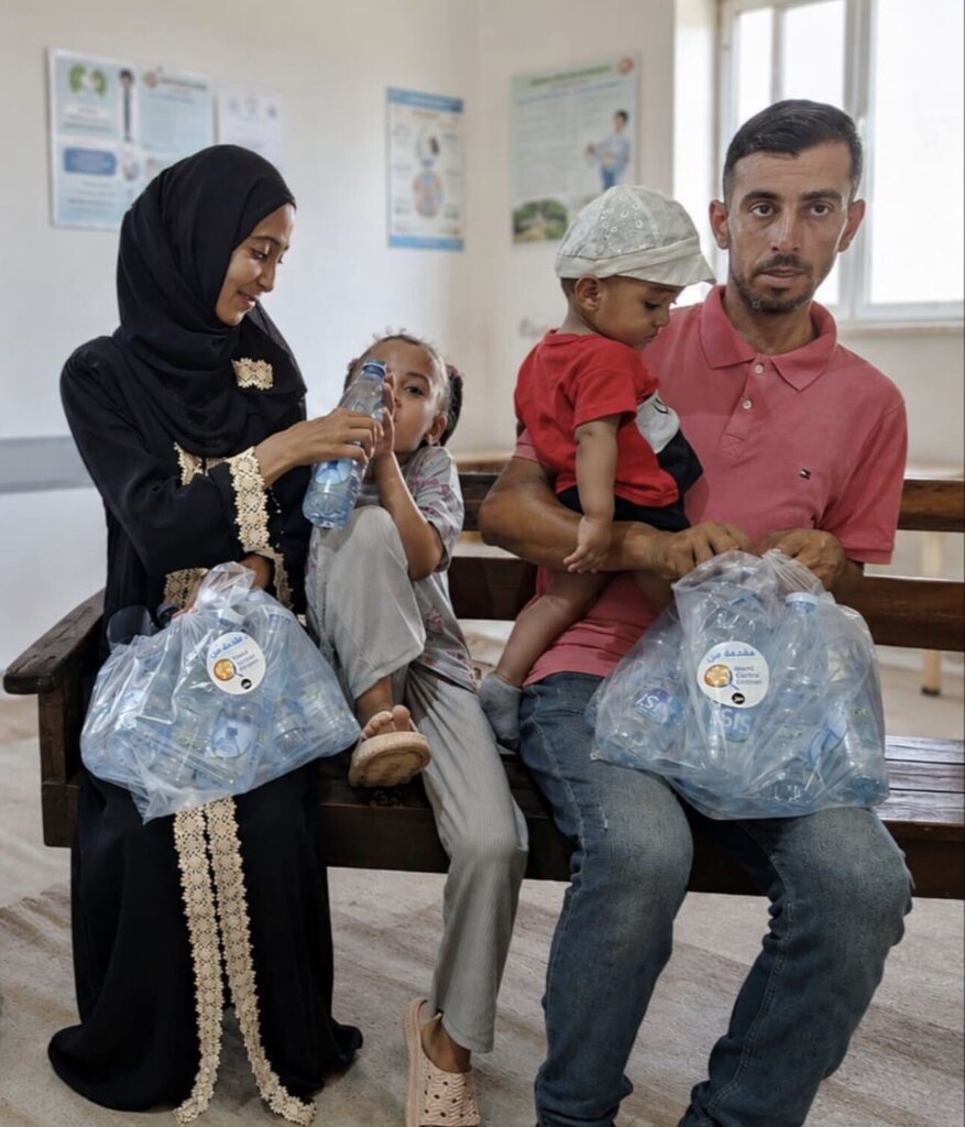 A family with fresh bottled water at a hospital