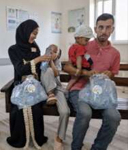 A family with fresh bottled water at a hospital