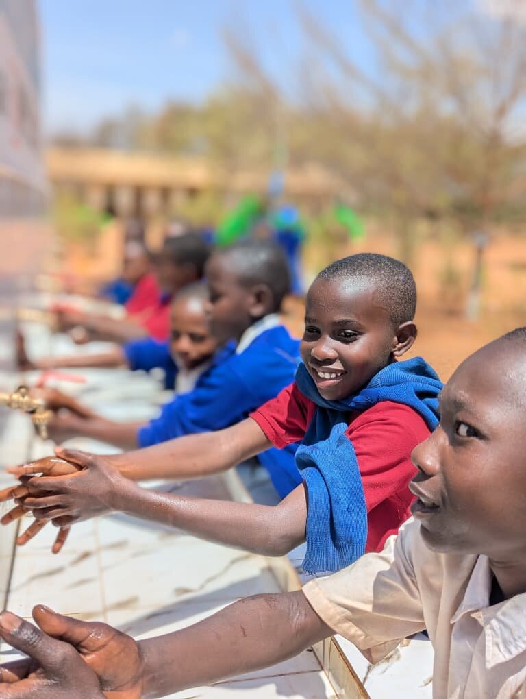 Pupils wash hand in newly built station