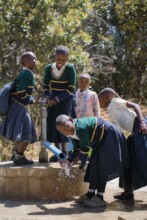Pupil enjoying a water in Mangalali primary