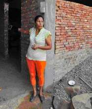 Delia Alarcon in front of her house