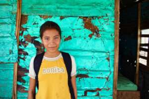 Angelis outside her family's one-room home.