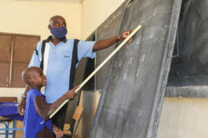 Ousmane* works with his teacher.