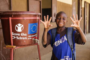 Ousmane* shows off his clean hands before class.