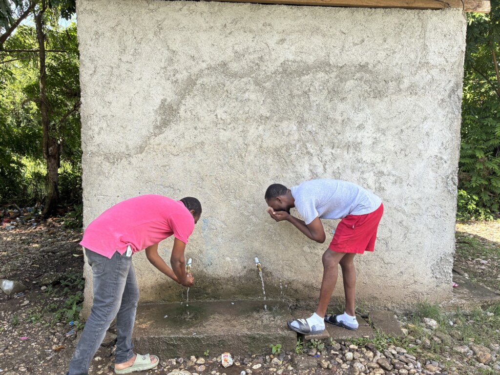 Staff drinking clean water at a new site