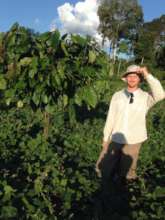 Ryan Smith with a cacao tree he planted in 2017