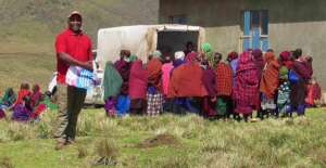 Dr. Shemaghembe happily distributes mosquito nets