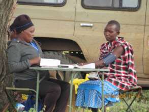 Woman Having Blood Pressure Read at Tawisa Post