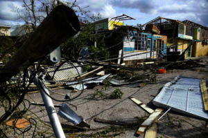 A downed utility pole blocks a street in Jamaica