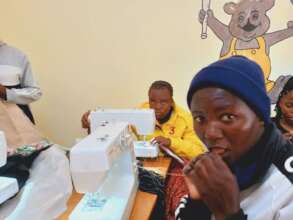 Young people learning hand stitching