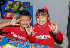 Yulissa and Lalo sharing a moment in sign language