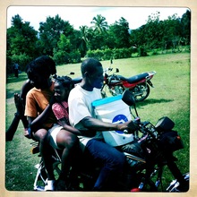 family on motorcycle with water