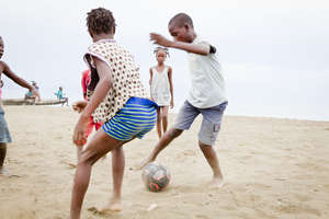 Community Kids playing Soccer with their New Ball
