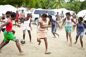 Community Girls playing Soccer with their New Ball