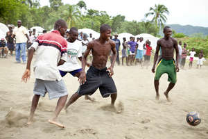 Community Boys playing Soccer with their New Ball