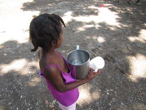 Girl on Sideline Waiting w/ a Drink of Clean Water