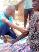 health personnel checking elderly blood pressure