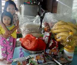 Helping put away the groceries from the food bank.