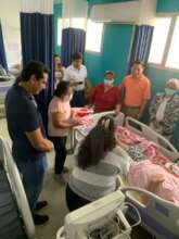 Presenting a new mother with handmade baby items.