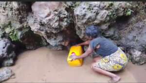 A woman collecting water before Phase 1