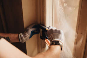 Volunteer Securing Protective Film