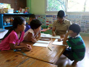 Ms. Lasang correcting the students homework