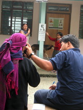 Dr. Tabin giving an eye exam. Photo by Chryl Martin.