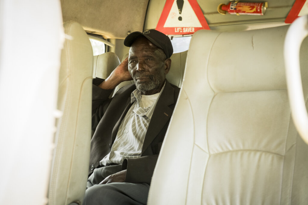 Paul waits as the van picks up another patient.